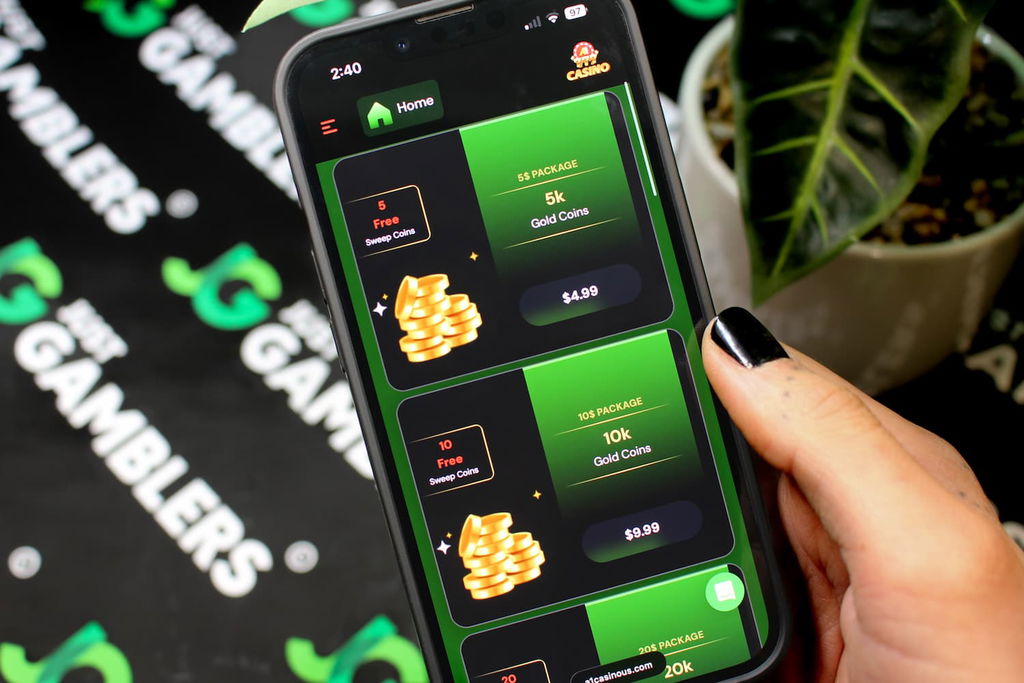 Angela Zillich holding an iPhone with the A1 casino coin packages page loaded on the webpage.