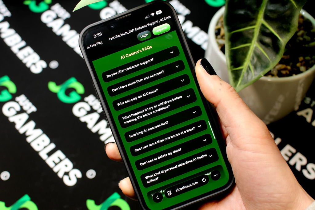 Angela Zillich holding an iPhone with the A1 casino FAQ page loaded on the webpage.