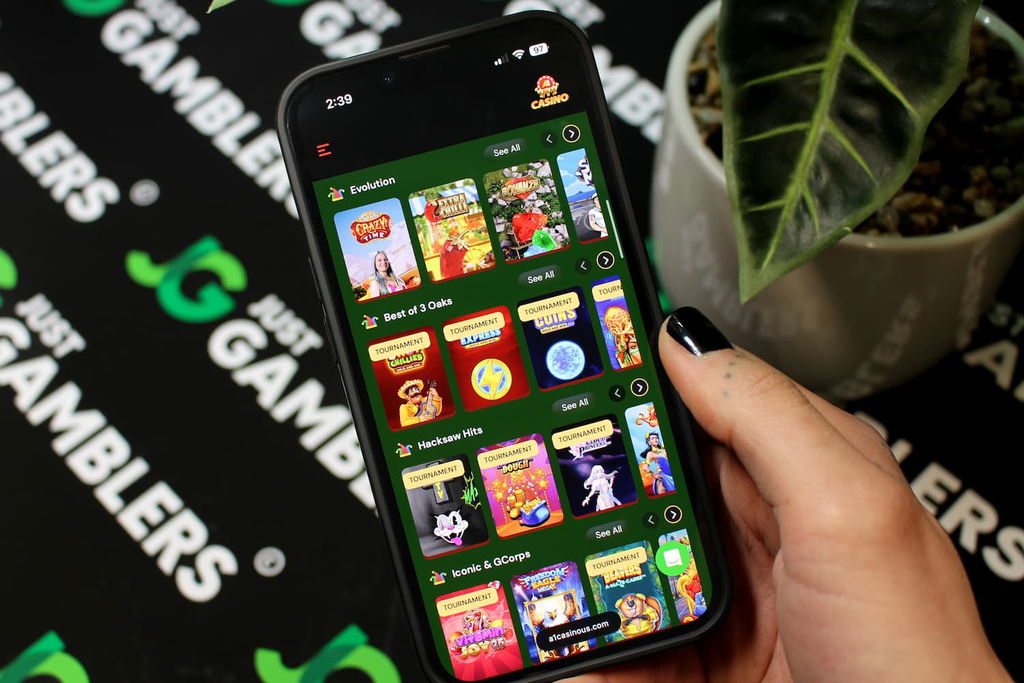 Angela Zillich holding an iPhone with the A1 casino gaming library page loaded on the webpage.