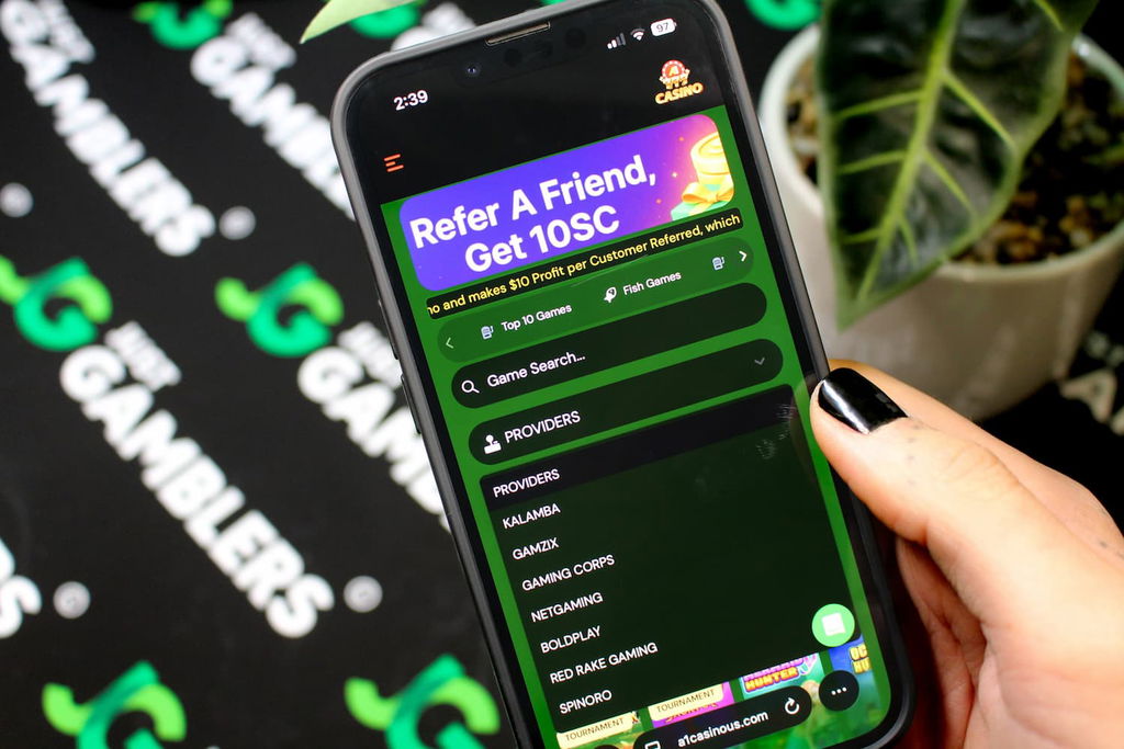 Angela Zillich holding an iPhone with the A1 casino software providers page loaded on the webpage.