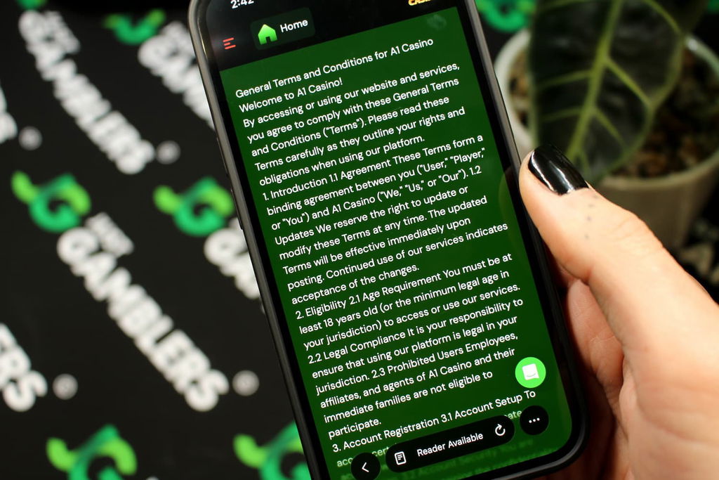 Angela Zillich holding an iPhone with the A1 casino Terms and Conditions page loaded on the webpage.