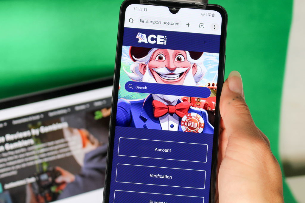 Angela Zillich holding an iPhone with the Ace casino Customer Support page loaded on the webpage.