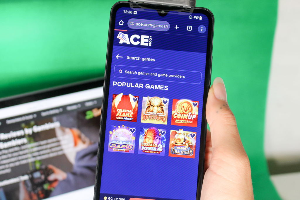 Angela Zillich holding an iPhone with the Ace casino usability search function loaded on the webpage.