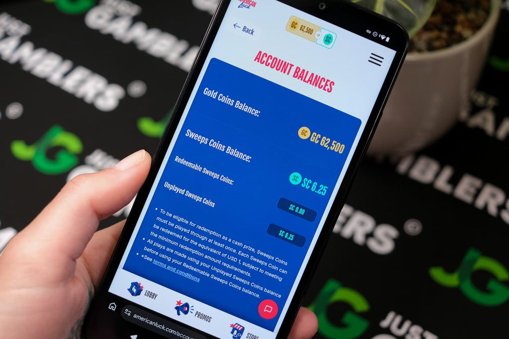 Angela Zillich holding an Android Phone with the American Luck casino account balance page loaded on the webpage.