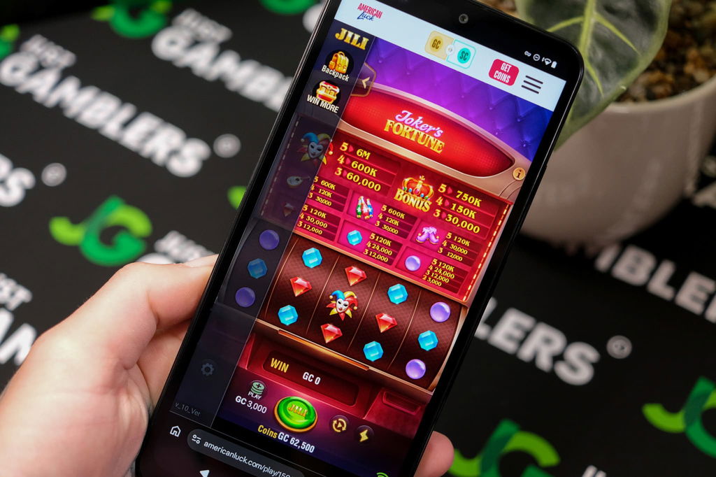 Angela Zillich holding an Android Phone with the American Luck casino mobile in-game page loaded on the webpage.