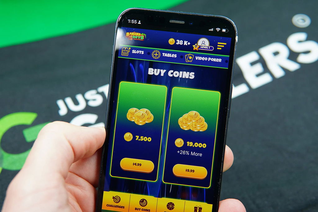 Patrik Lidin holding an iPhone showing offers for BananaBets coin packages.