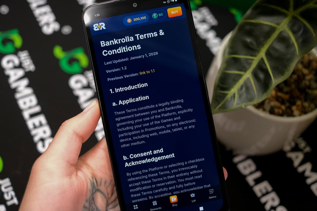 Angela Zillich holding an Android Phone with the Bank Rolla casino Terms and Conditions page loaded on the webpage.