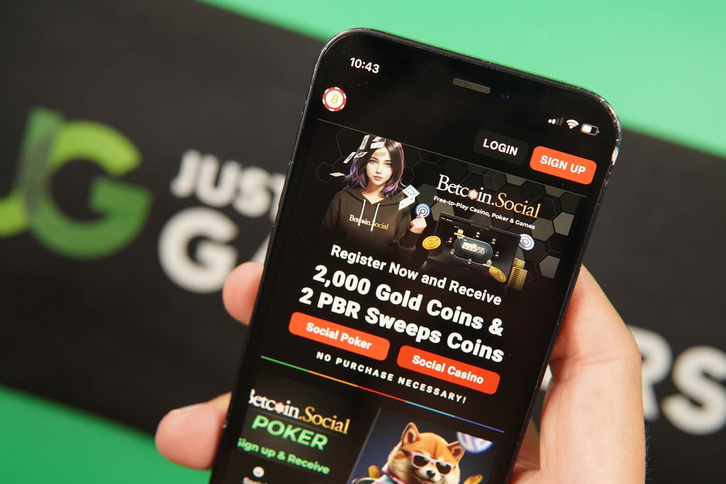 Patrik Lidin holding an iPhone with the BetcoinSocial casino landing page loaded on the webpage.