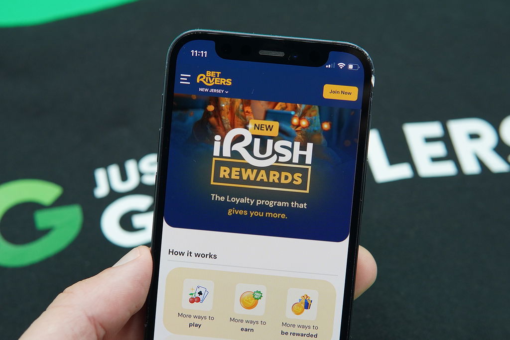 Photo of Patrik Lidin holding an iaPhone with the BetRivers iRush loyalty program loaded.