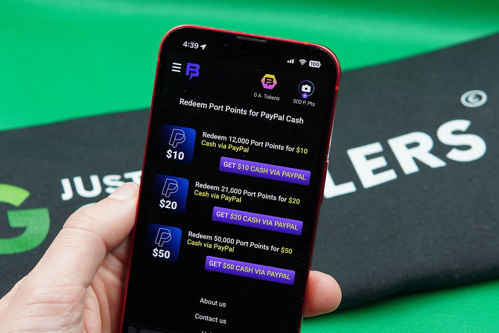 Patrik Lidin holding an iPhone with the Bingoport PayPal redemptions loaded on the webpage.