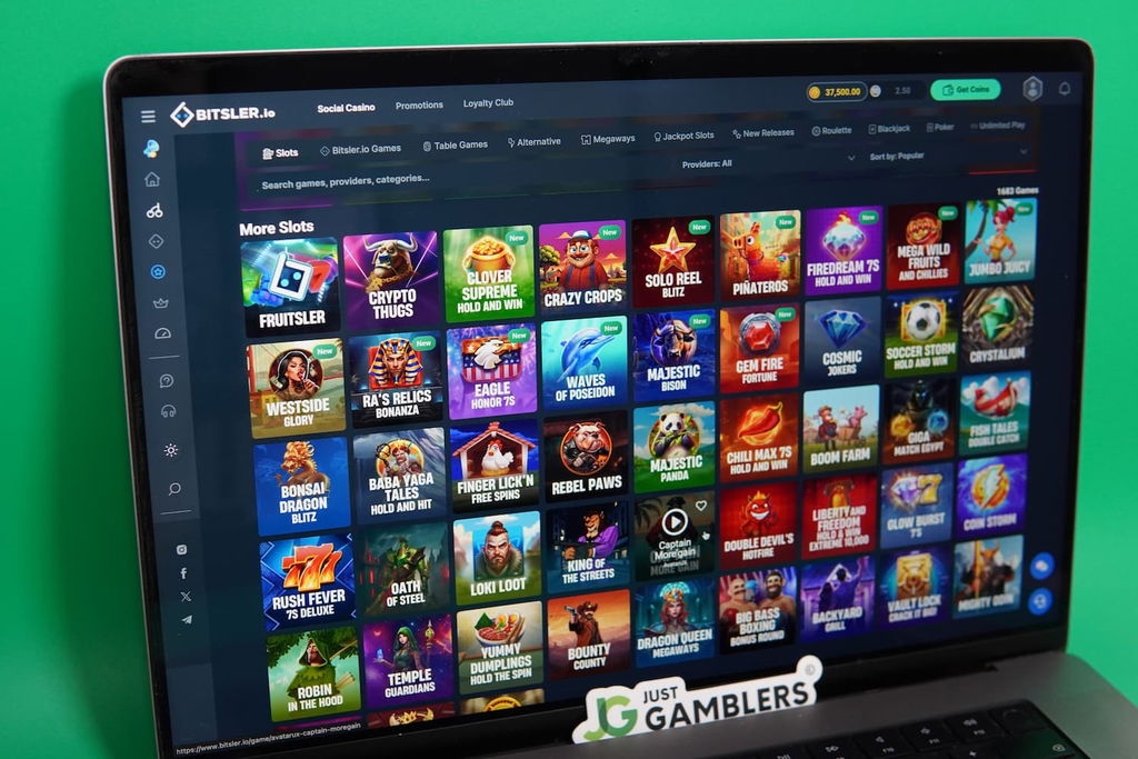 Patrik Lidin holding an iPhone with the Bitsler.io casino game library page loaded on the webpage.