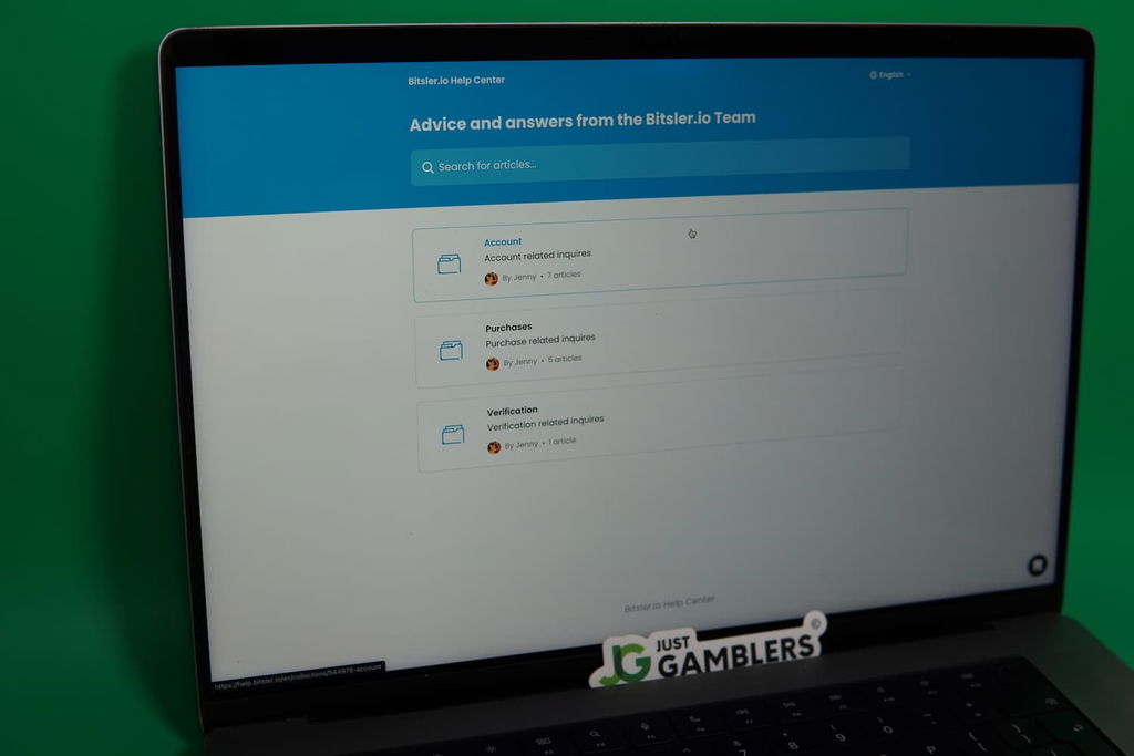 Patrik Lidin holding an iPhone with the Bitsler.io casino support page loaded on the webpage.