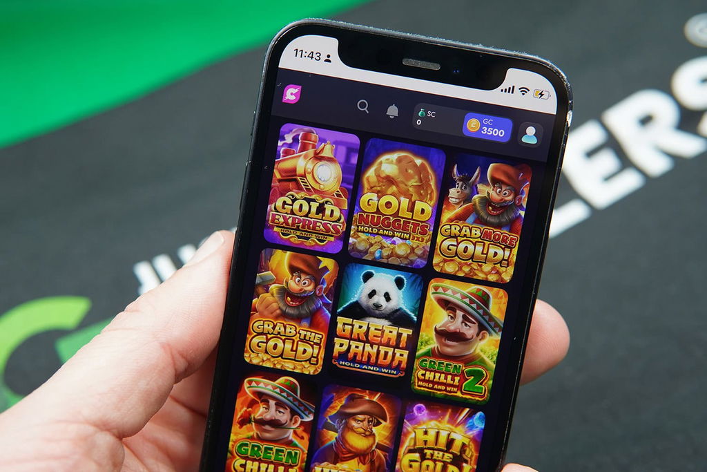 Patrik Lidin holding an iPhone with Cashoomo game library showing.