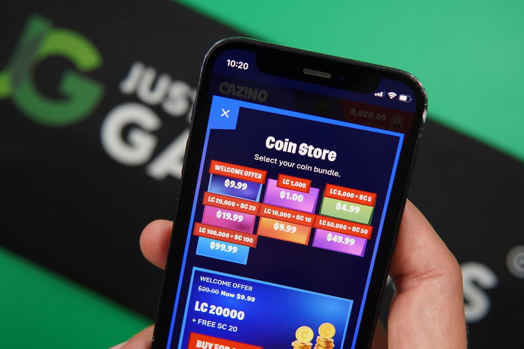 Patrik Lidin holding an iPhone with the Cazino casino coin store page loaded on the webpage.