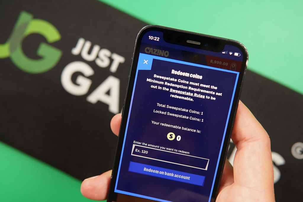 Patrik Lidin holding an iPhone with the Cazino casino redemptions page loaded on the webpage.