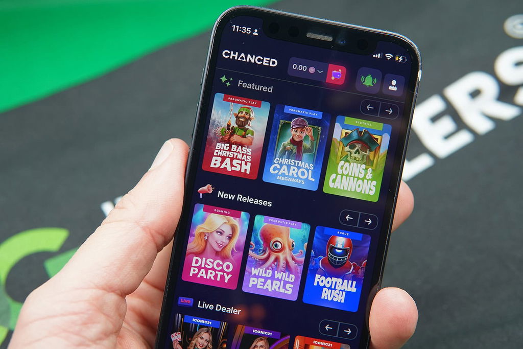 Patrik Lidin holding an iPhone with Chanced game library showing.