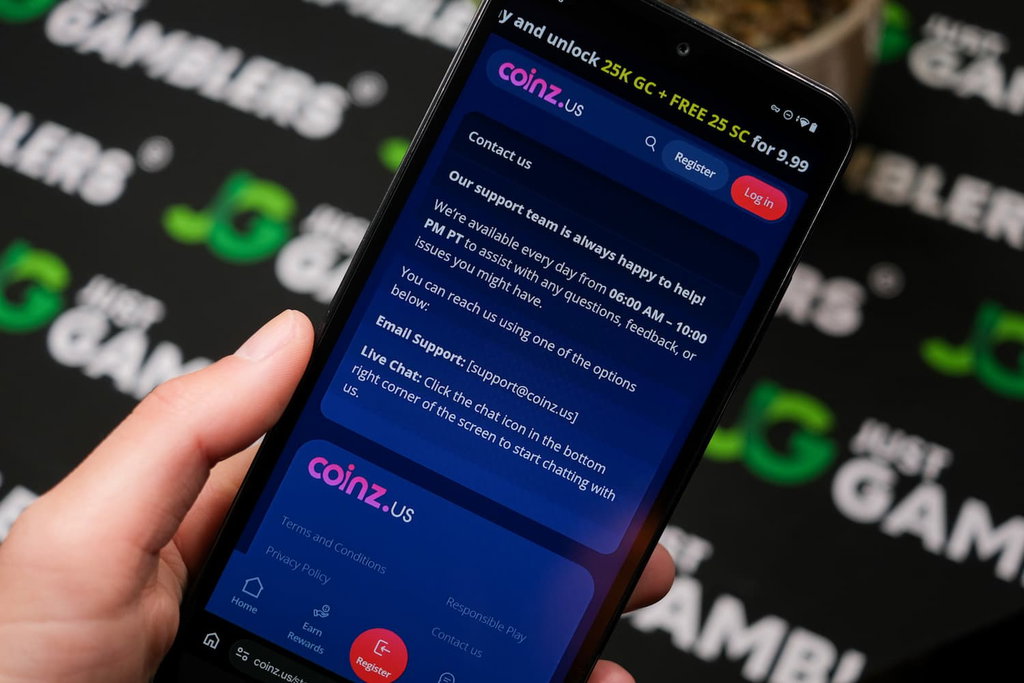 Angela Zillich holding an Android Phone with Coinz.us casino Contact Us page loaded on the webpage.