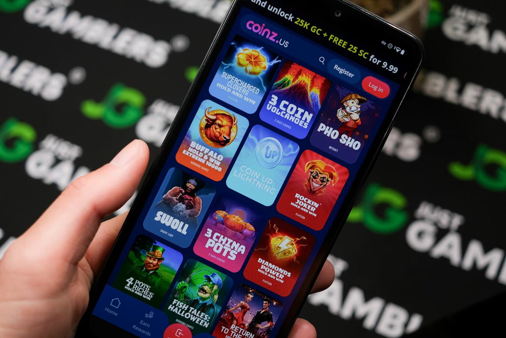 Angela Zillich holding an Android Phone with Coinz.us casino gaming library page loaded on the webpage.