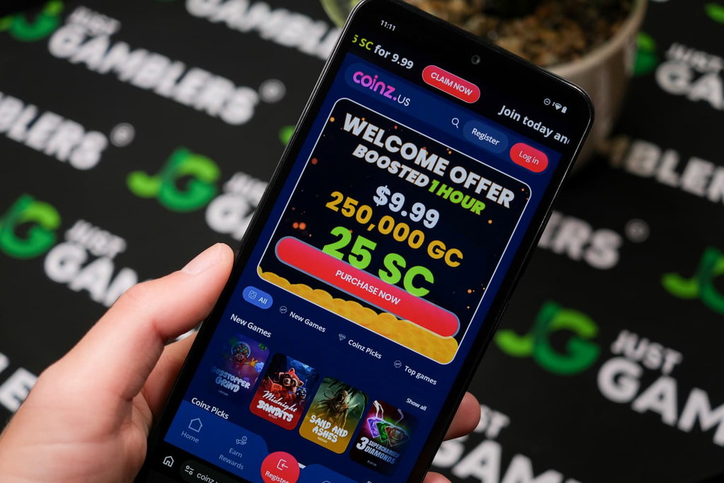 Angela Zillich holding an Android Phone with Coinz.us casino landing page loaded on the webpage.