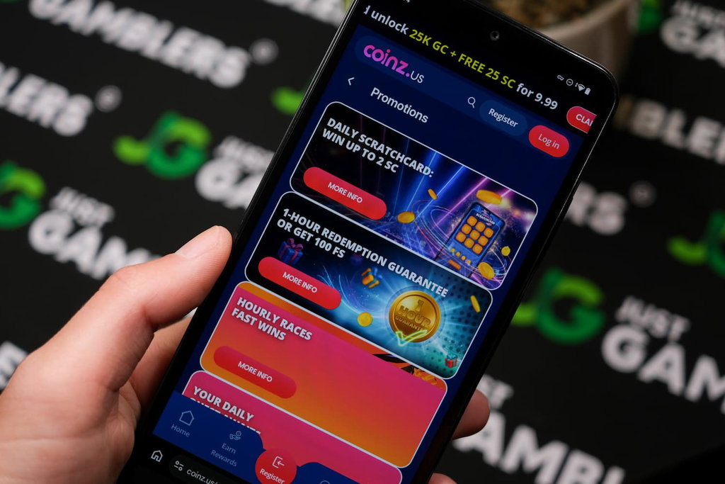 Angela Zillich holding an Android Phone with Coinz.us casino Promotions page loaded on the webpage.