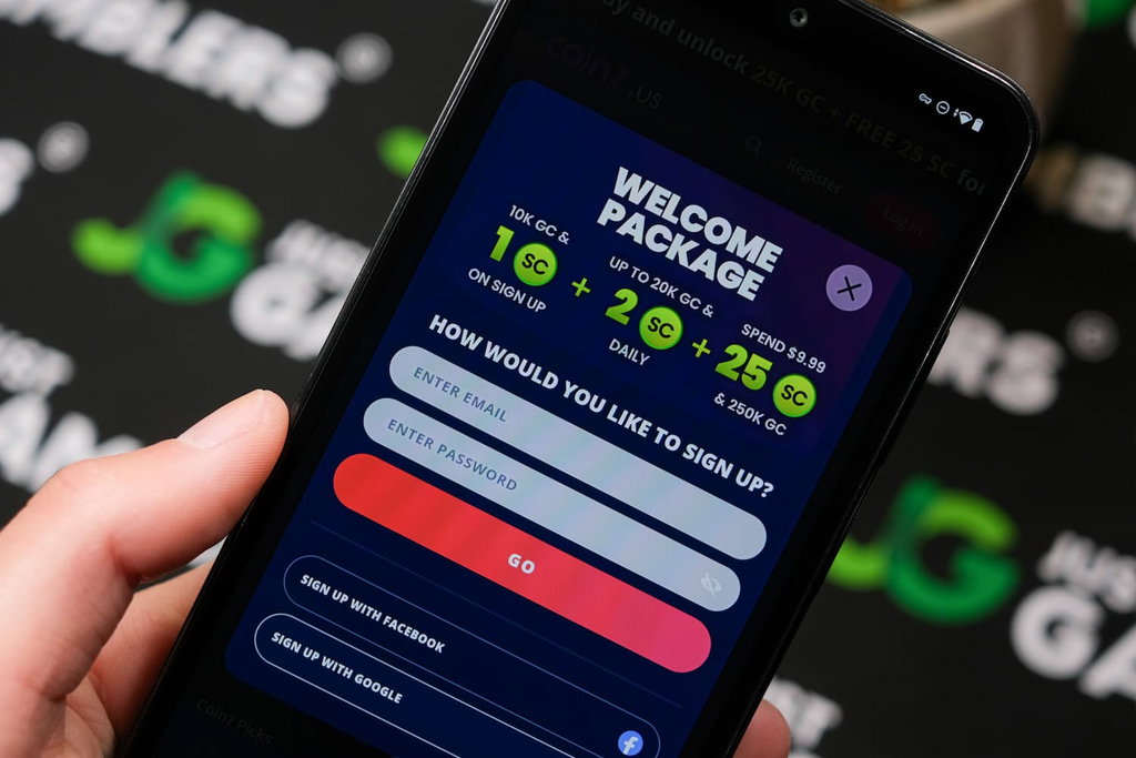 Angela Zillich holding an Android Phone with Coinz.us casino Registration page loaded on the webpage.