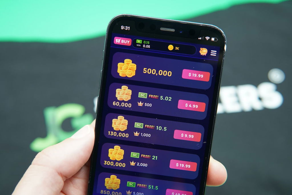 Patrik Lidin holding an iPhone with the Coolspin casino coin purchase page loaded on the webpage.