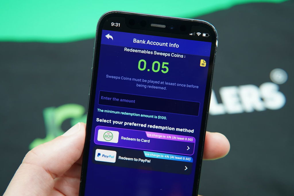 Patrik Lidin holding an iPhone with the Coolspin casino redemptions page loaded on the webpage.