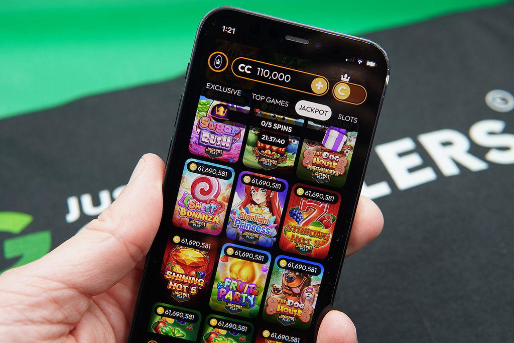 Photo of Patrik Lidin holding iPhone with Crown Coins Casino and games from trusted providers.