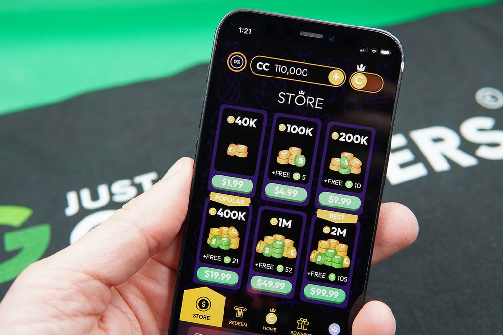 Patrik Lidin holding an iPhone showing offers for Crown Coins Casino coin packages.