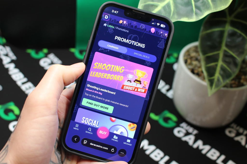 Angela Zillich holding an iPhone with the Dara casino promotions page loaded on the webpage.