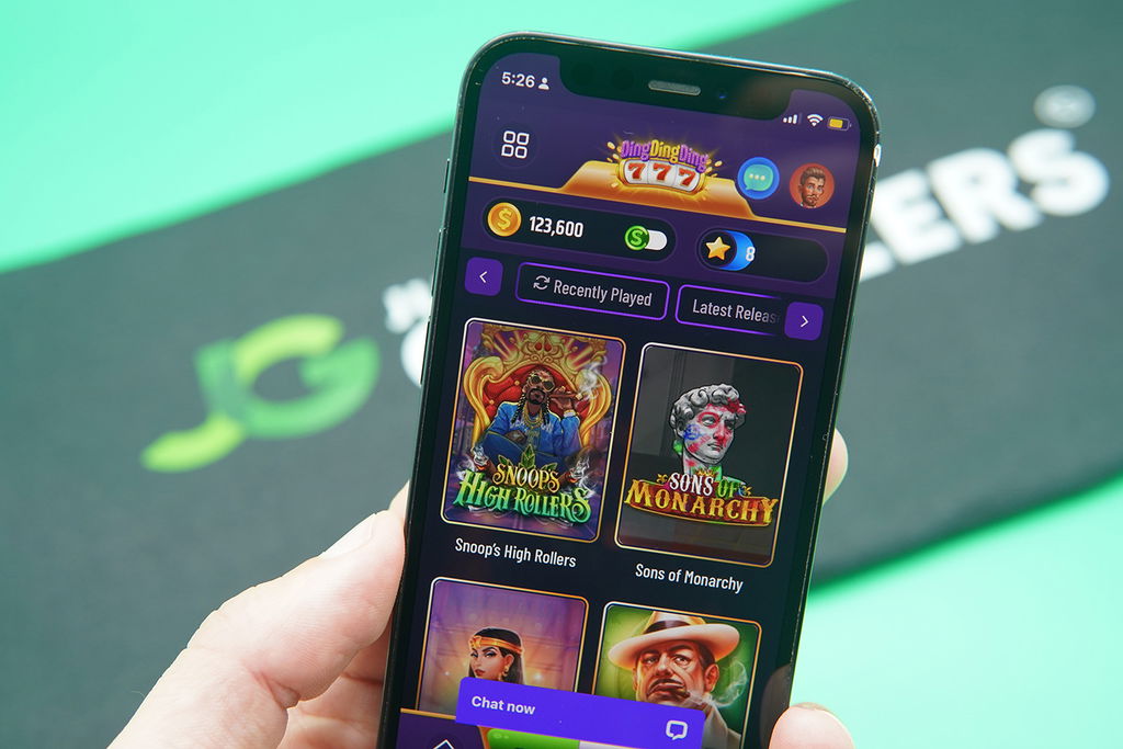 Patrik Lidin holding an iPhone with DingDingDing game library showing.