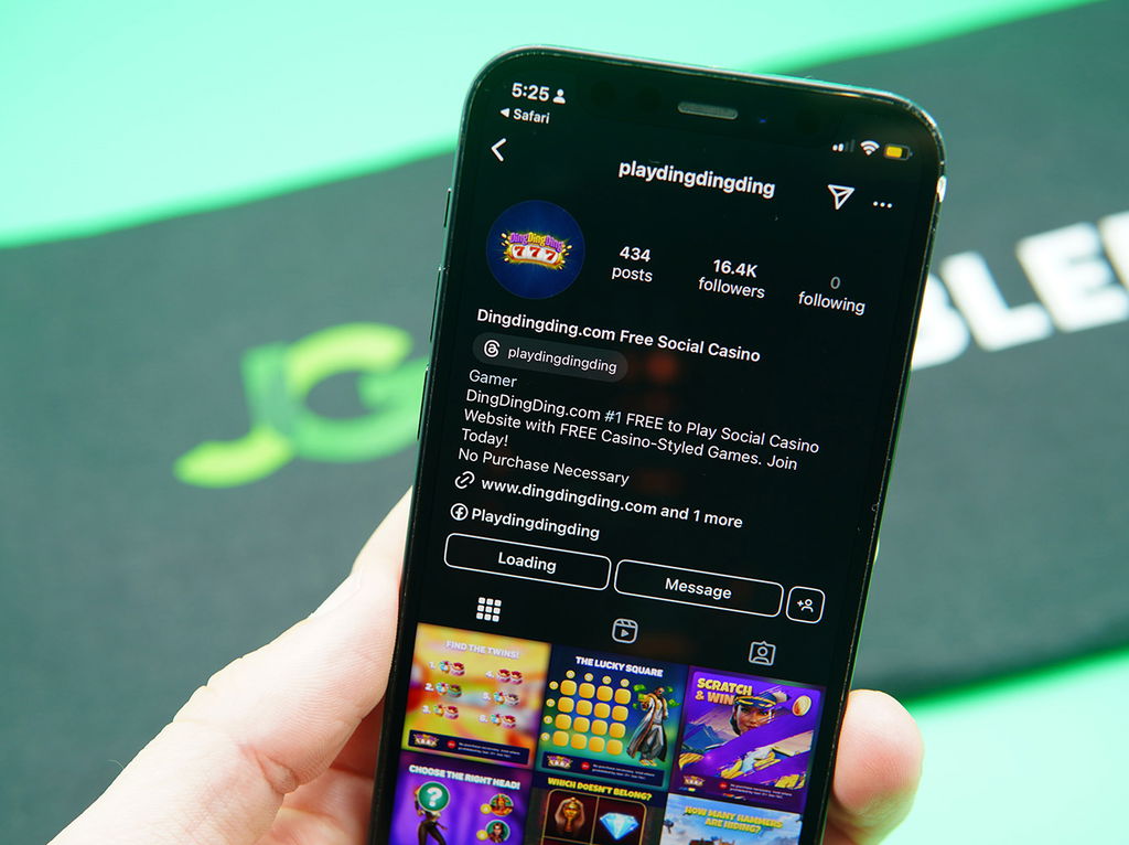 Patrik Lidin holding an iPhone with the DingDingDing Instagram account.