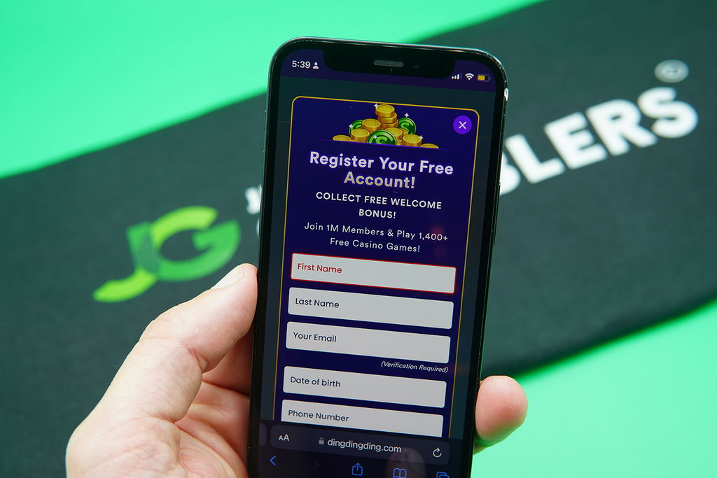 Patrik Lidin holding an iPhone showing the DingDingDing registration process.