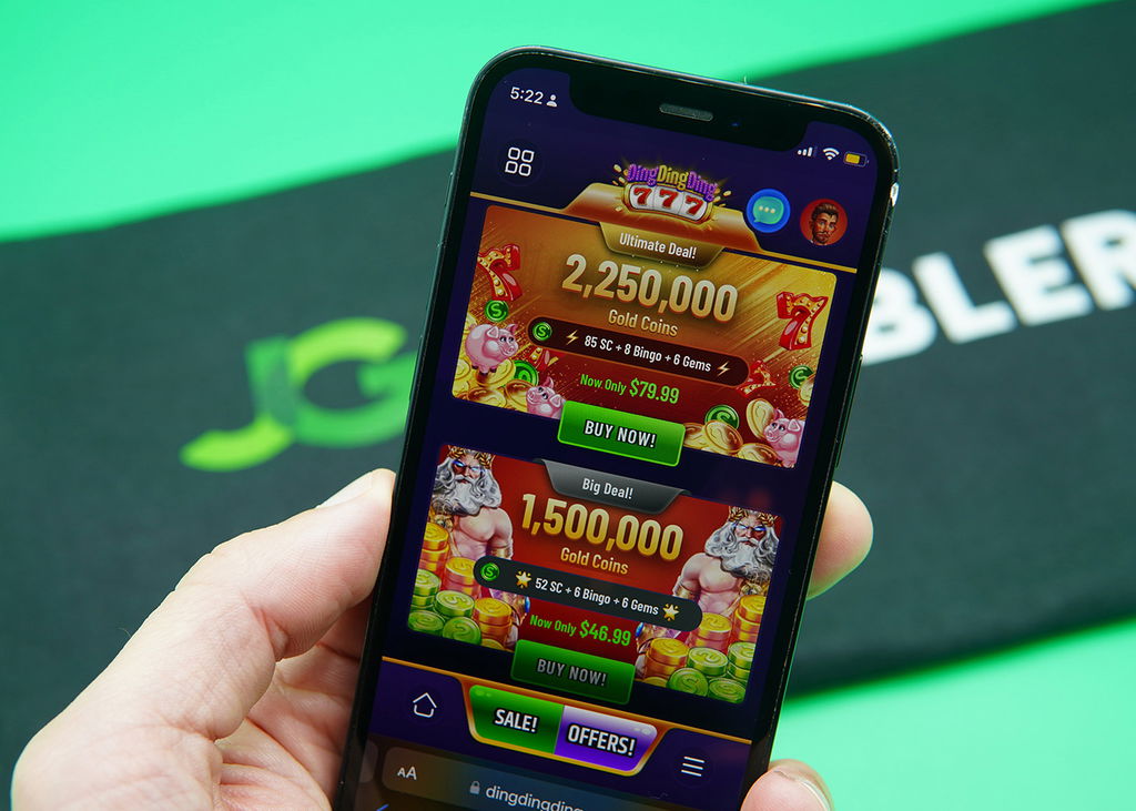 Patrik Lidin holding an iPhone with the DingDingDing rewards page loaded on the webpage.