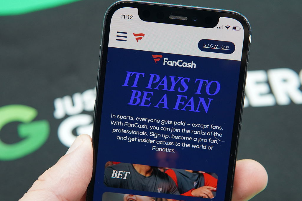 Photo of Patrik Lidin holding an iPhone with the Fanatics FanCash loyalty program loaded.