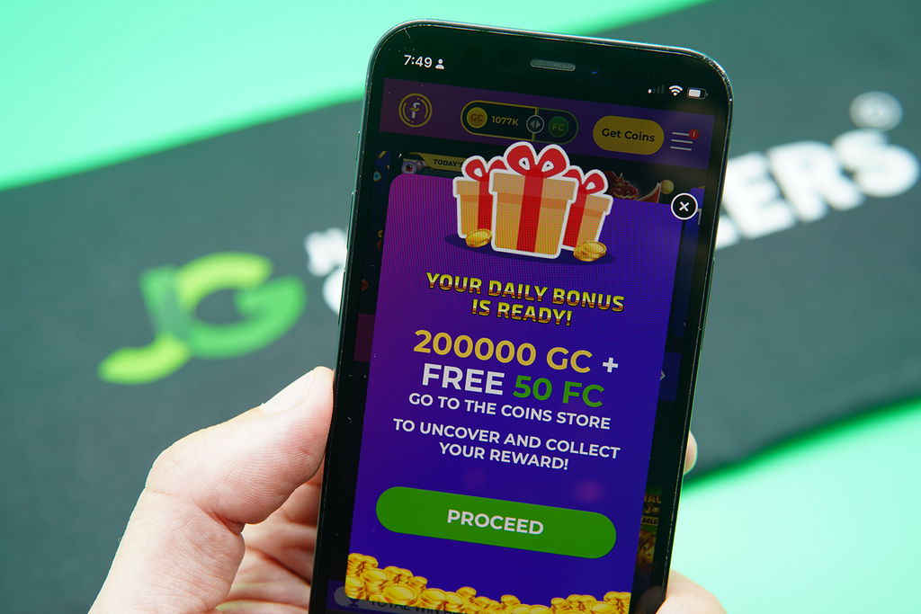 Photo of Patrik Lidin holding an iPhone showing the Fortune Coins daily free rewards.