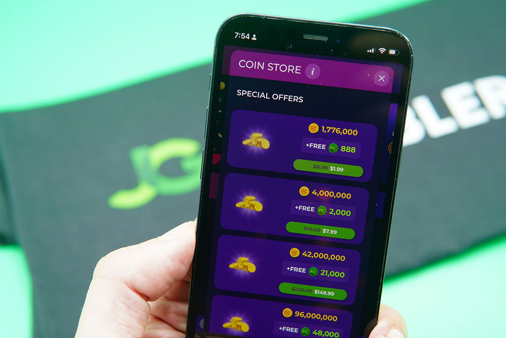 Patrik Lidin holding an iPhone when purchasing coins on Fortune Coins casino.