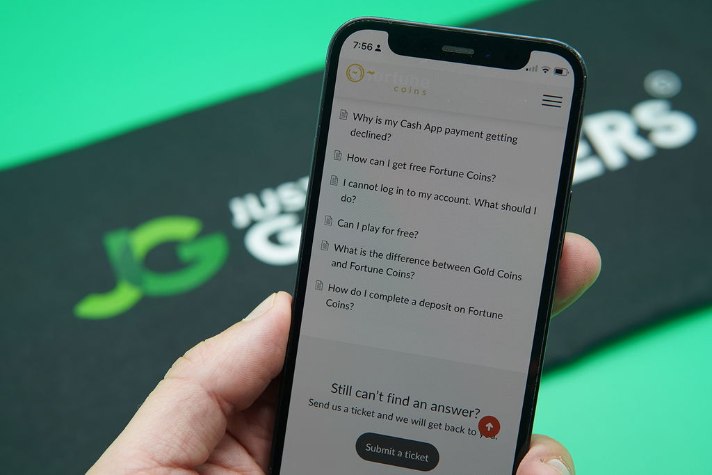 Patrik Lidin holding an iPhone while using the Fortune Coins customer support.