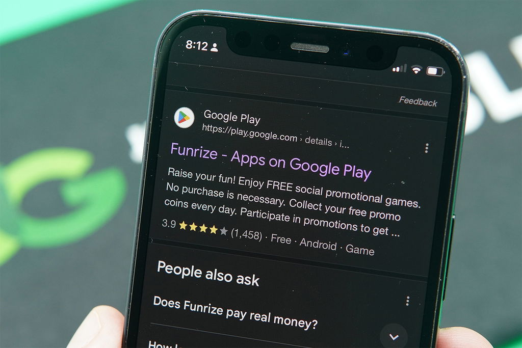 Patrik Lidin holding an iPhone with the Funrize app in Apple App Store.
