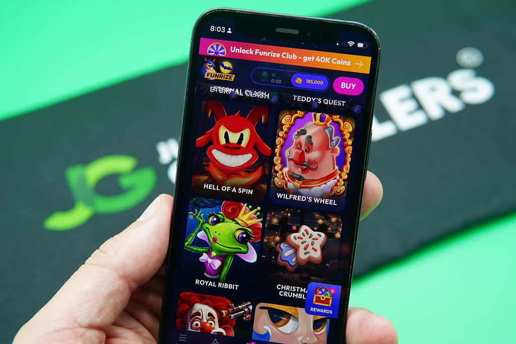 Patrik Lidin holding an iPhone with Funrize game library showing.