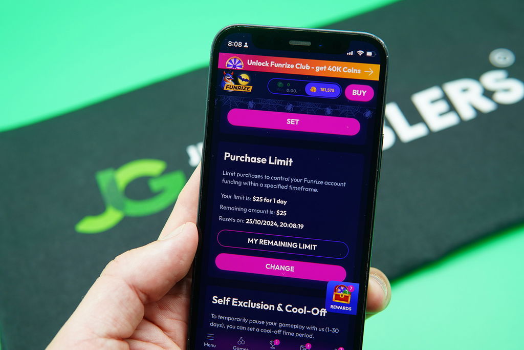 Patrik Lidin holding an iPhone with the Funrize responsible gambling page showing.