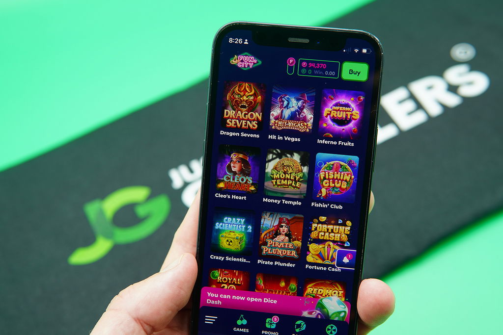 Patrik Lidin holding an iPhone with FunzCity game library showing.