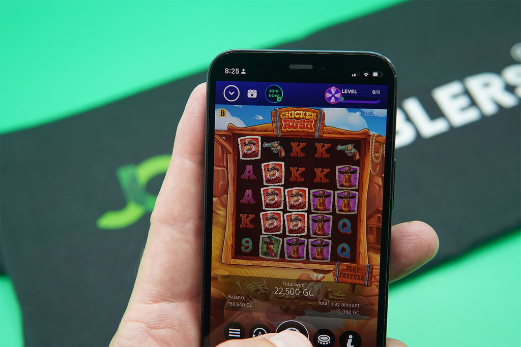 Patrik Lidin holding an iPhone with FunzCity casino game Chicken Rush showing.