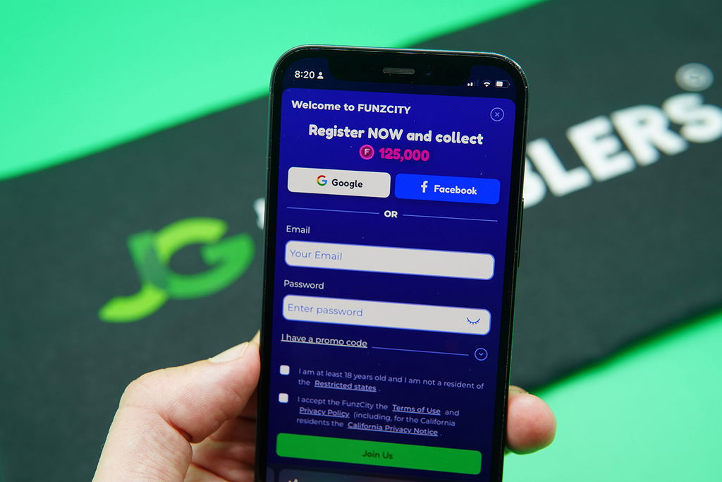 Patrik Lidin holding an iPhone showing the FunzCity registration process.