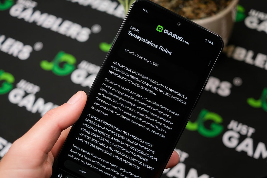 Angela Zillich holding an Android Phone with Gains casino AMOE page loaded on the webpage.