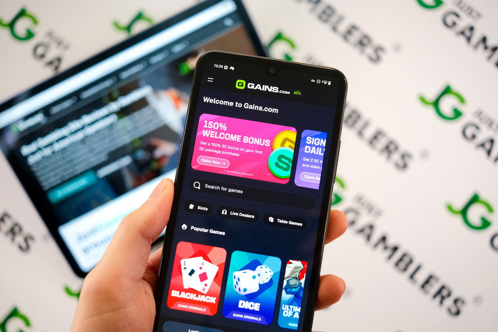 Angela Zillich holding an Android Phone with the Gains casino landing page loaded on the webpage.