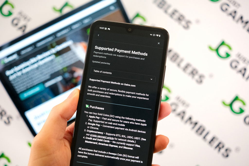 Angela Zillich holding an Android Phone with the Gains casino payment methods page loaded on the webpage.
