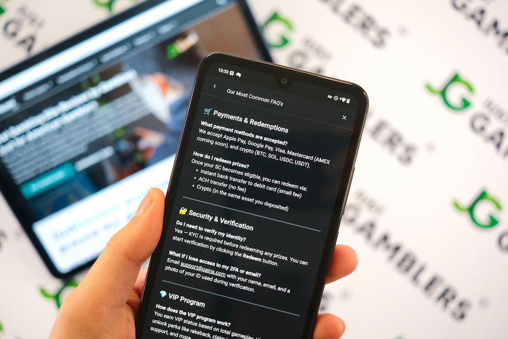 Angela Zillich holding an Android Phone with the Gains casino payments redemptions page loaded on the webpage.