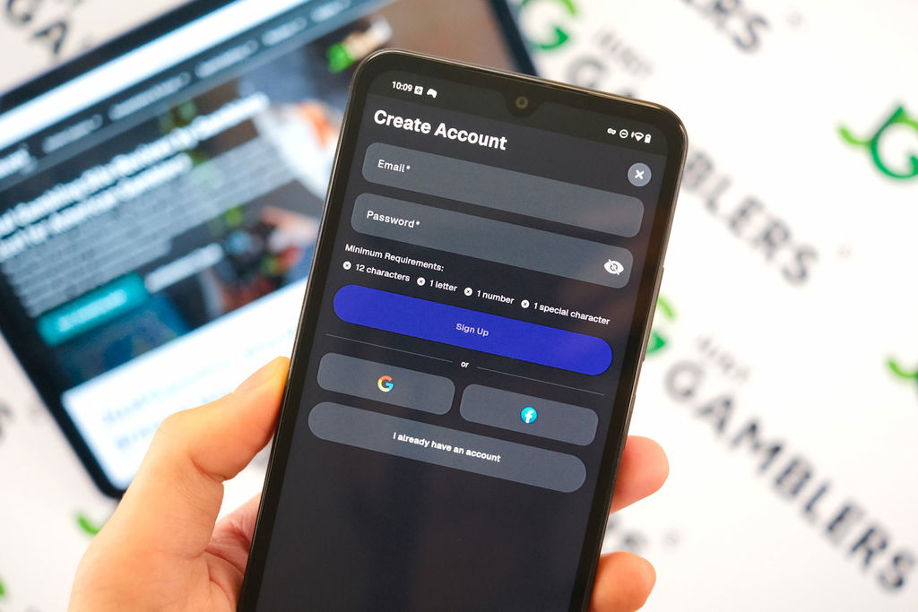 Angela Zillich holding an Android Phone with the Gains casino registration page loaded on the webpage.