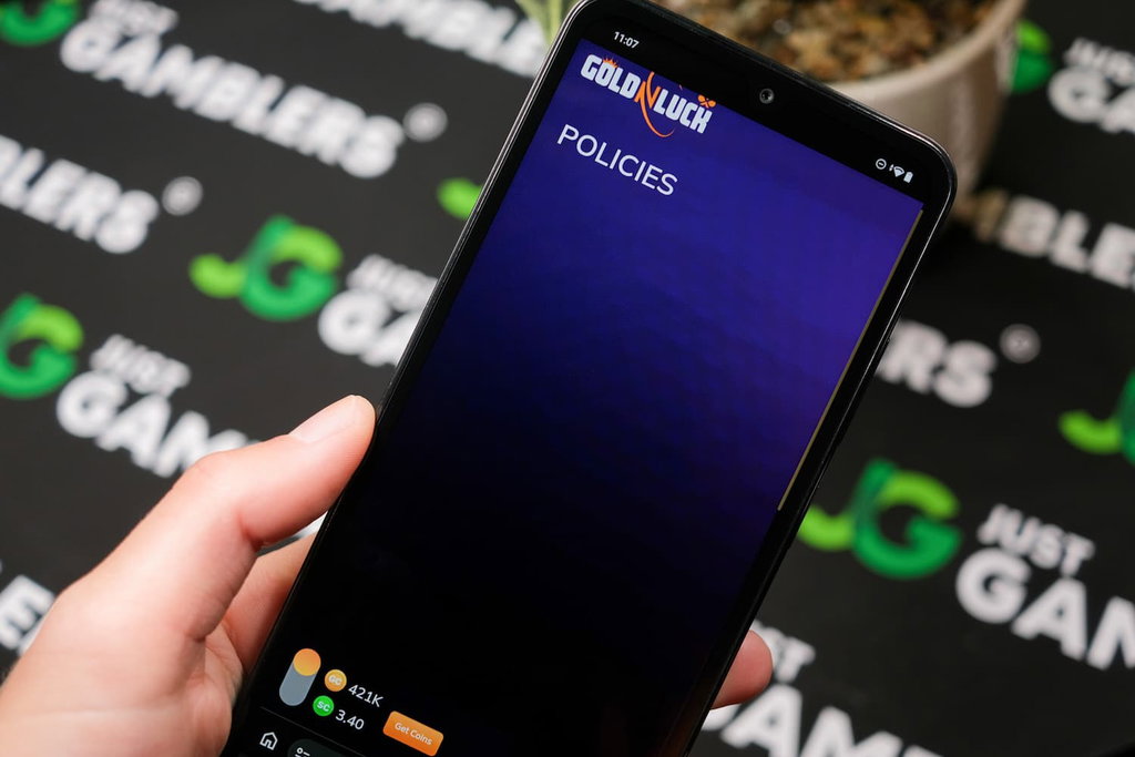 Angela Zillich holding an Android Phone with GoldNLuck casino AMOE page loaded on the webpage.